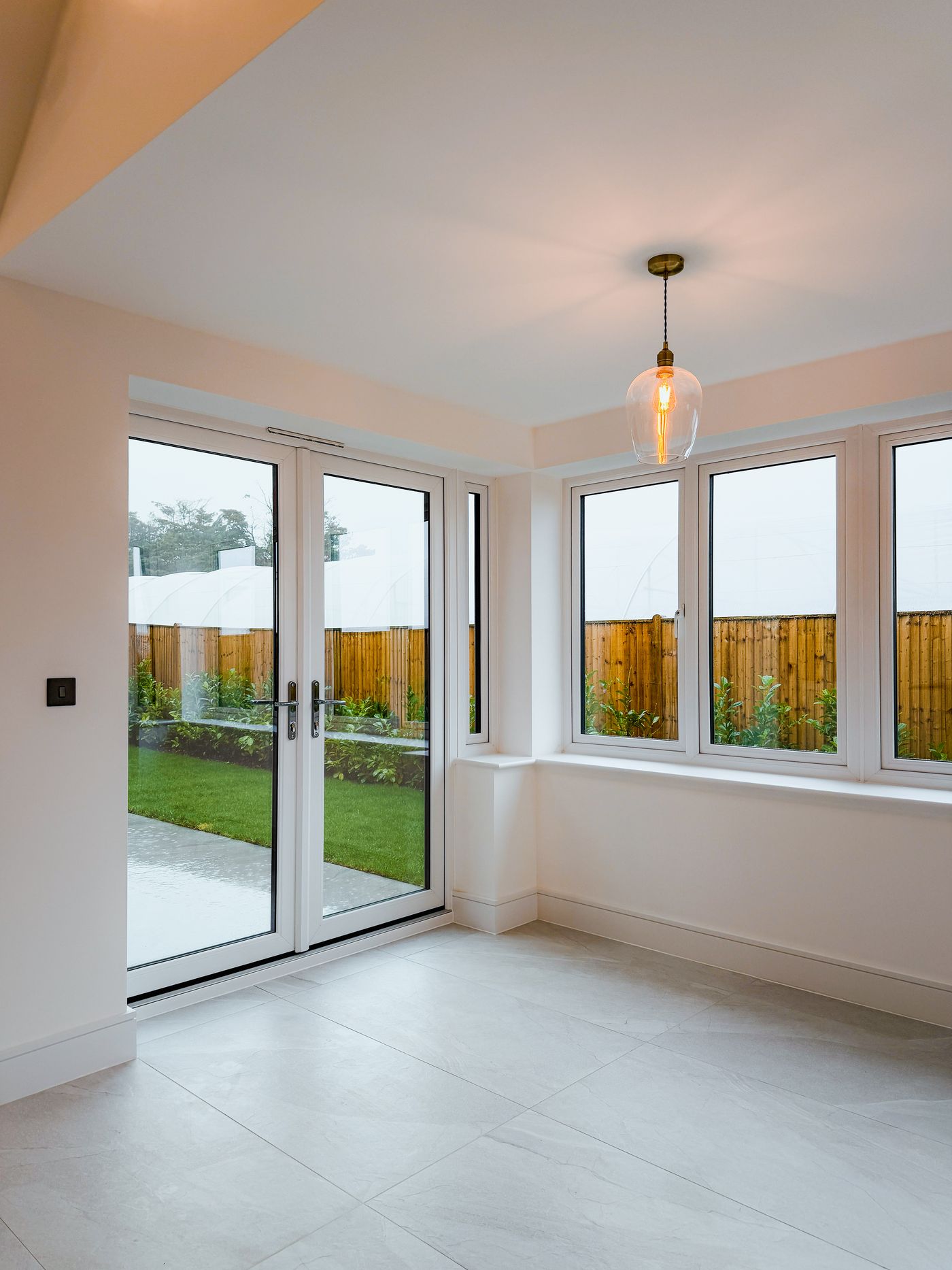 Tiled garden room with a pendant light